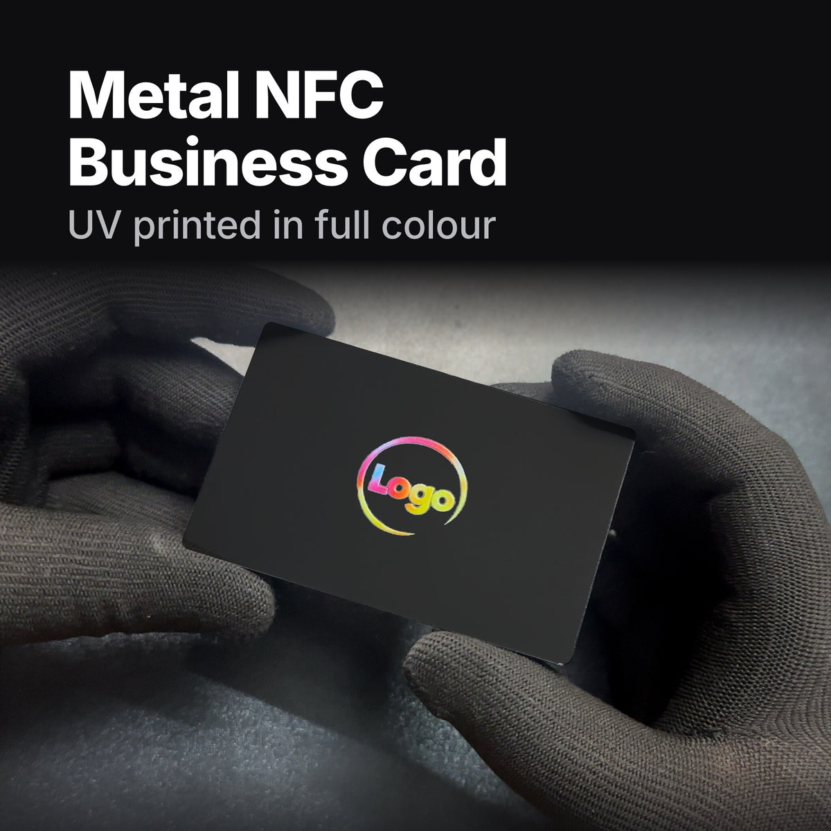 Hands holding a black hybrid stainless steel NFC business card with a full-colour UV-printed logo