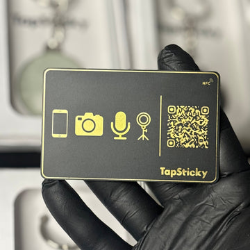 Real black TapSticky card with gold foil, held in a hand