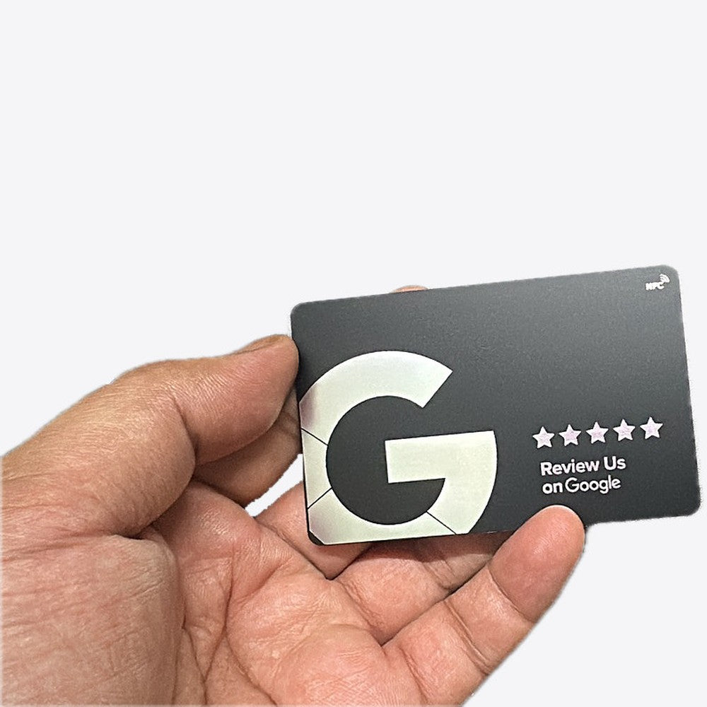 Google review NFC card in matte black with a silver G and five stars, held in a hand